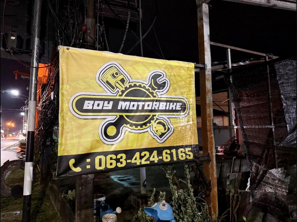 Boy Motorbike yellow sign glowing at night on Chaofah East Rd